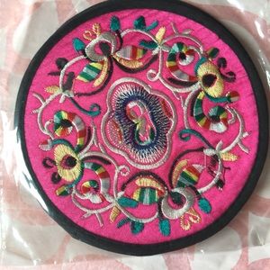 A pair of embroidered coasters